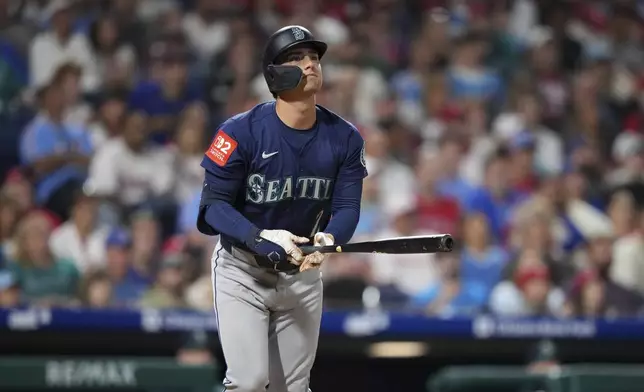 Seattle Mariners' Cole Young watches after hitting a three-run home run against Philadelphia Phillies pitcher Jordan Romano during the seventh inning of a baseball game Monday, Aug. 18, 2025, in Philadelphia. (AP Photo/Matt Slocum)