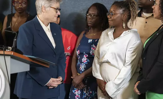 Hennepin County Attorney Mary Moriarty announces that Bryan Hooper Sr. would be freed after 27 years, after another prisoner confessed to the the murder, in Minneapolis, Minn., on Tuesday, Aug. 12, 2025. Bryan's daughter, Briana Hooper, is at right. (Richard Tsong-Taatarii/Star Tribune via AP)
