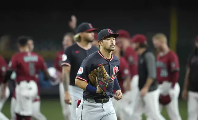 Cleveland Guardians left fielder Steven Kwan jogs off the field as the Arizona Diamondbacks celebrate a walk-off single hit by Diamondbacks' Adrian Del Castillo after a baseball game Wednesday, Aug. 20, 2025, in Phoenix. (AP Photo/Ross D. Franklin)