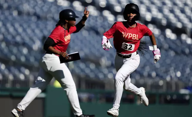 Mo'ne Davis, right, scores a run during a game on the fourth day of tryouts for the Women's Professional Baseball League, Monday, Aug. 25, 2025, at Nationals Park in Washington. (AP Photo/Julia Demaree Nikhinson)