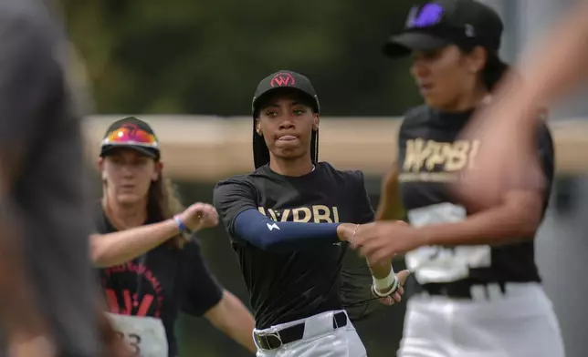 Mo'ne Davis, center, and other players warm up during the third day of tryouts for the Women's Professional Baseball League, Sunday, Aug. 24, 2025, at the Washington Nationals Youth Baseball Academy in Washington. (AP Photo/Julia Demaree Nikhinson)