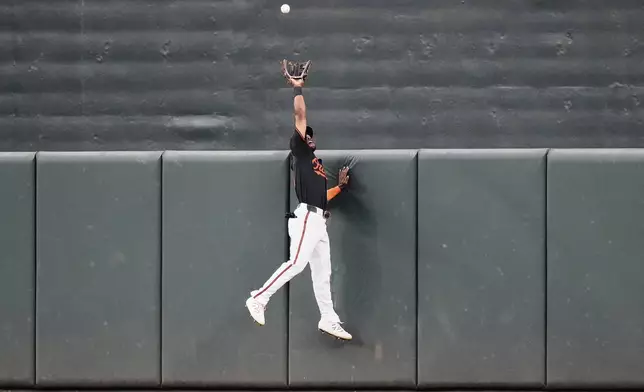 Baltimore Orioles center fielder Cedric Mullins jumps to catch a fly ball hit by Toronto Blue Jays' Nathan Lukes for the out during the fourth inning of a baseball game, Monday, July 28, 2025, in Baltimore. (AP Photo/Stephanie Scarbrough)