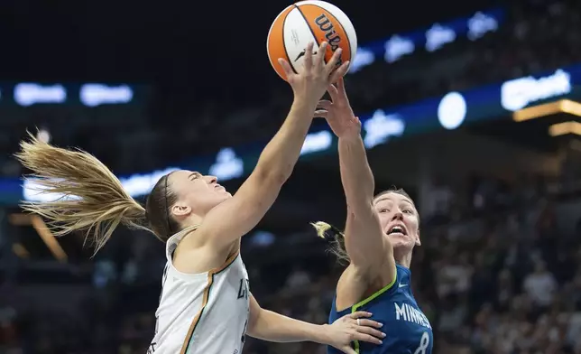 Minnesota Lynx forward Alanna Smith (8) blocks a lay-up attempt by New York Liberty guard Sabrina Ionescu (20) late in the fourth quarter of a WNBA basketball game Saturday, Aug. 16, 2025, in Minneapolis. (Alex Kormann/Star Tribune via AP)