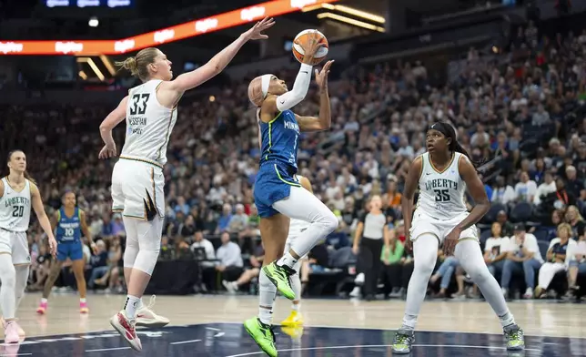 Minnesota Lynx guard DiJonai Carrington (3) attempts a layup while being defended by New York Liberty center Emma Meesseman (33) during the first half of an WNBA basketball game in Minneapolis, Minn., Saturday, Aug. 16, 2025. (Alex Kormann/Star Tribune via AP)