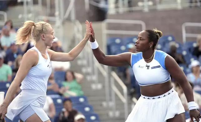 Katerina Siniakova, left, of the Czech Republic, and her partner Taylor Townsend, of the United States, congratulate each other after winning a point during their doubles match against Aldila Sutjiadi, of Indonesia, and Nadiia Kichenok, of Ukraine, in the second round of the U.S. Open tennis championships, Thursday, Aug. 28, 2025, in New York. (AP Photo/Frank Franklin II)