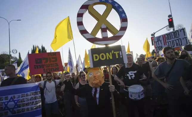 Relatives and supporters of Israeli hostages held in the Gaza Strip attend a rally demanding their release from Hamas captivity and calling for an end to the war outside the prime minister's office in Jerusalem, Thursday, Aug. 7, 2025. (AP Photo/Ohad Zwigenberg)
