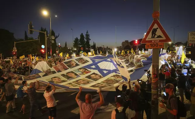 Relatives and supporters of Israeli hostages held in the Gaza Strip attend a rally demanding their release from Hamas captivity and calling for an end to the war outside the prime minister's office in Jerusalem, Thursday, Aug. 7, 2025. (AP Photo/Ohad Zwigenberg)