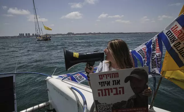 Relatives and supporters of Israeli hostages held by Hamas sail along the coast of Israeli southern city of Ashkelon towards the Gaza Strip, in a protest demanding their release from captivity and calling for an end to the war Thursday, Aug. 7, 2025. (AP Photo/Leo Correa)