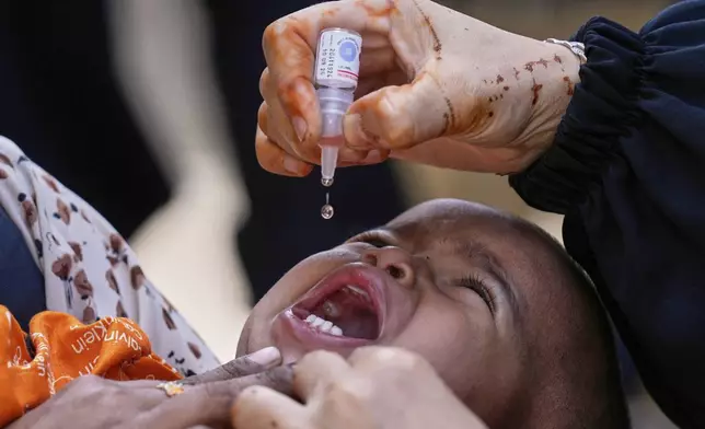 A health worker administers a polio vaccine to a child in Karachi, Pakistan, April 21, 2025. (AP Photo/Fareed Khan)
