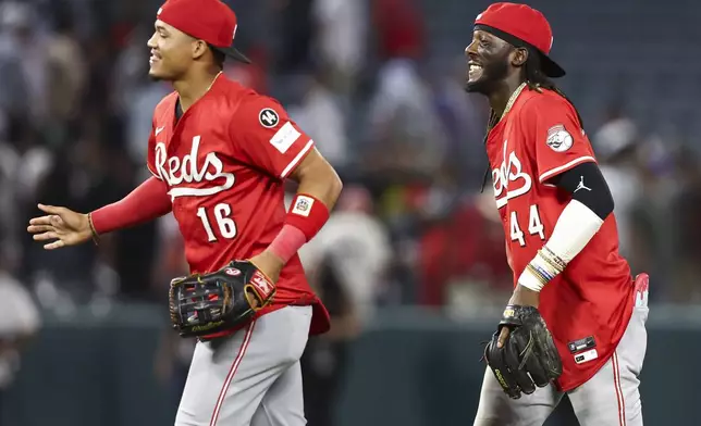 Cincinnati Reds shortstop Elly De La Cruz (44) reacts alongside right fielder Noelvi Marte (16) after the Reds defeat the Angels in a baseball game, Monday, Aug. 18, 2025, in Anaheim, Calif. (AP Photo/Jessie Alcheh)