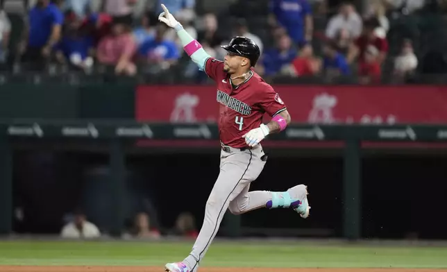 Arizona Diamondbacks' Ketel Marte celebrates his three-run home run in the ninth inning of a baseball game against the Texas Rangers Wednesday, Aug. 13, 2025, in Arlington, Texas. (AP Photo/Tony Gutierrez)