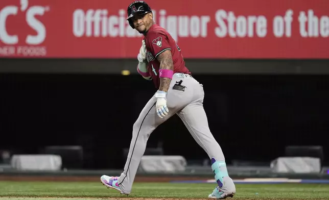 Arizona Diamondbacks' Ketel Marte celebrates after hitting a three-run home run in the ninth inning of a baseball game against the Texas Rangers Wednesday, Aug. 13, 2025, in Arlington, Texas. (AP Photo/Tony Gutierrez)