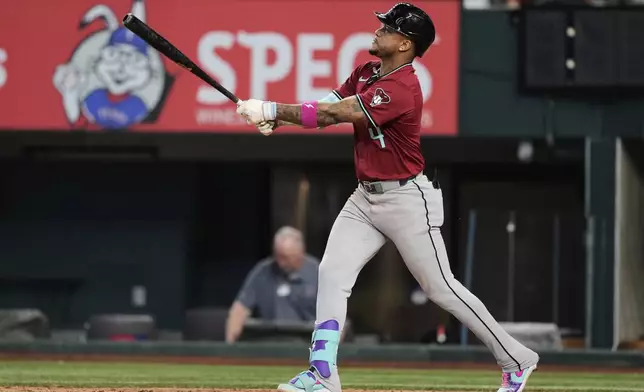 Arizona Diamondbacks' Ketel Marte follows through on his three-run home run in the ninth inning of a baseball game against the Texas Rangers Wednesday, Aug. 13, 2025, in Arlington, Texas. (AP Photo/Tony Gutierrez)