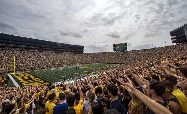 FILE - Michigan fans in the student section of Michigan Stadium cheer during the second quarter of an NCAA college football game against Western Michigan in Ann Arbor, Mich., Saturday, Sept. 4, 2021. (AP Photo/Tony Ding, FIle(