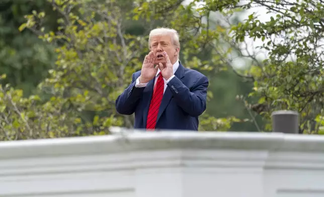 President Donald Trump shouts to reporters as he surveys the grounds from the roof above the Colonnade that goes to the West Wing of the White House, Tuesday, Aug. 5, 2025, in Washington. (AP Photo/Alex Brandon)