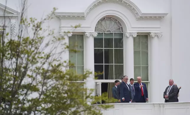 President Donald Trump, second from the right, with architect James McCrery, center, surveys the grounds from the roof above the Colonnade that goes to the West Wing of the White House, Tuesday, Aug. 5, 2025, in Washington. (AP Photo/Evan Vucci)
