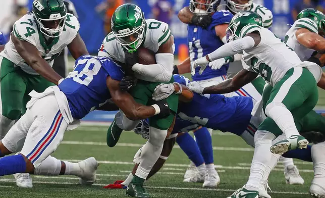 New York Jets running back Braelon Allen (0) carries the ball against the New York Giants during the first quarter of an NFL football game, Saturday, Aug. 16, 2025, in East Rutherford, N.J. (AP Photo/Noah K. Murray)