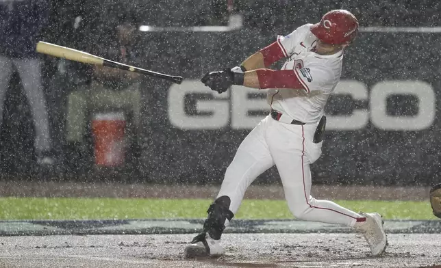 Cincinnati Reds TJ Friedl lets go of the bat in the rain during the first inning of the MLB Speedway Classic baseball game between the Atlanta Braves and the Cincinnati Reds at Bristol Motor Speedway in Bristol, Tenn., Saturday, Aug. 2, 2025. (AP Photo/George Walker IV)