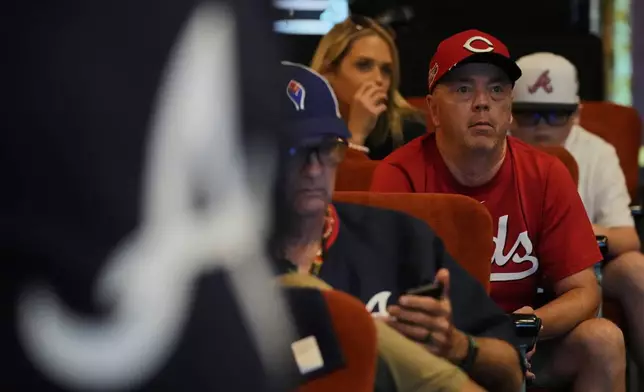 Cincinnati Reds fan Ron Young during watches the Reds play the Atlanta Braves during a watch party at the Paramount Theater, Friday, Aug. 1, 2025, in Bristol, Tenn., the day before the MLB Speedway Classic baseball game between the two teams. (AP Photo/George Walker IV)
