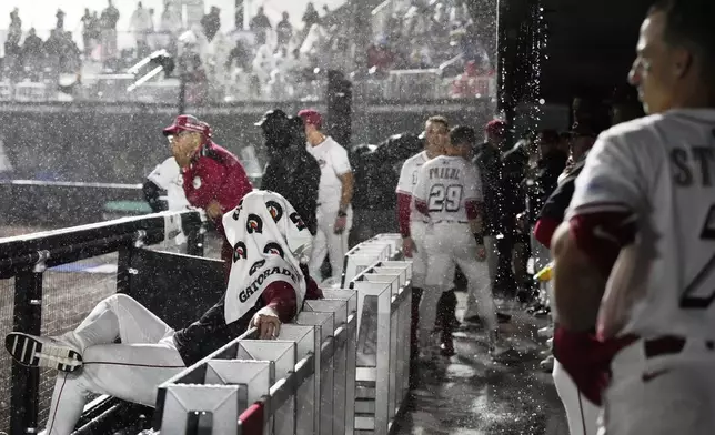 Cincinnati Reds wait during a rain delay in the first inning of the MLB Speedway Classic baseball game at Bristol Motor Speedway in Bristol, Tenn., Saturday, Aug. 2, 2025. (AP Photo/George Walker IV)