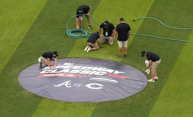 Members of the grounds crew prepare the field prior to the MLB Speedway Classic baseball game at Bristol Motor Speedway in Bristol, Tenn., Saturday, Aug. 2, 2025. (AP Photo/George Walker IV)
