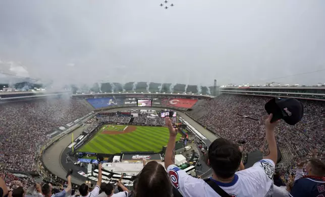 Fans cheer during a flyover before the MLB Speedway Classic baseball game between the Atlanta Braves and the Cincinnati Reds at Bristol Motor Speedway in Bristol, Tenn., Saturday, Aug. 2, 2025. (AP Photo/George Walker IV)