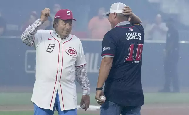 Cincinnati Reds legend Johnny Bench, and Atlanta Braves legend Chipper Jones prepared to throw out the ceremonial first pitch before the MLB Speedway Classic baseball game between the Atlanta Braves and the Cincinnati Reds at Bristol Motor Speedway in Bristol, Tenn., Saturday, Aug. 2, 2025. (AP Photo/Chris Carlson)