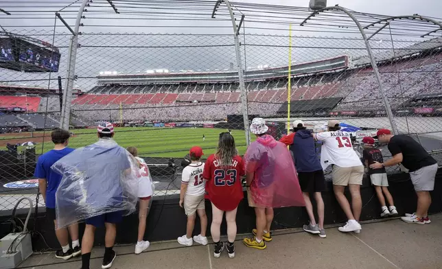 Fans watch during batting practice before the MLB Speedway Classic baseball game at Bristol Motor Speedway in Bristol, Tenn., Saturday, Aug. 2, 2025. (AP Photo/George Walker IV)