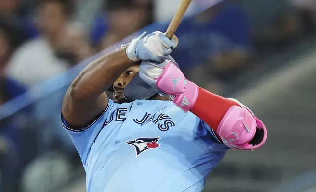 Toronto Blue Jays' Vladimir Guerrero Jr. (27) flies out against the Chicago Cubs during the fourth inning of a baseball game in Toronto on Wednesday, Aug. 13, 2025. (Nathan Denette/The Canadian Press via AP)
