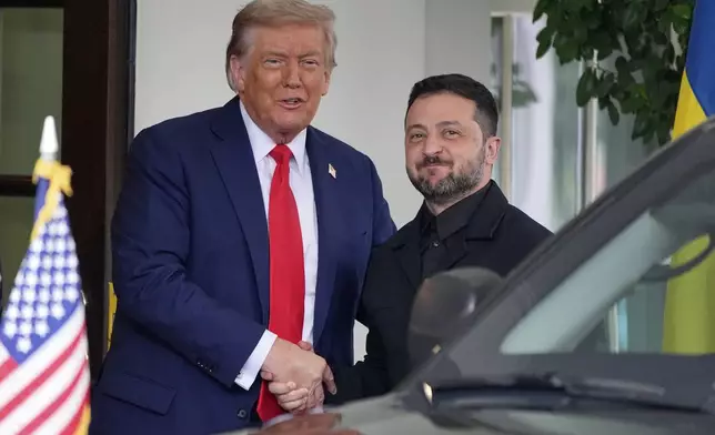 President Donald Trump, left, greets Ukraine's President Volodymyr Zelenskyy as he arrives at the White House, Monday, Aug. 18, 2025, in Washington. (AP Photo/Alex Brandon)