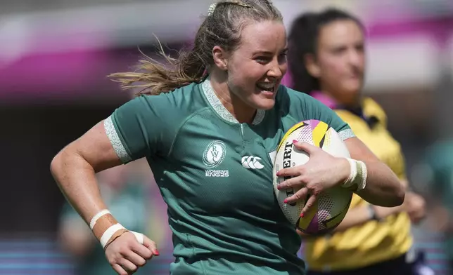 Ireland's Fiona Tuite runs on her way to score a try, during the group C match between Ireland and Japan of the 2025 Women's Rugby World Cup, in Northampton, England, Sunday, Aug. 24, 2025. (AP Photo/Dave Shopland)