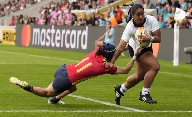 New Zealand's Ayesha Leti-I'iga breaks through and scores a try during the Women's Rugby World Cup 2025 Pool C match between New Zealand and Spain at York Community Stadium in York, England, Sunday, Aug. 24, 2025. (Danny Lawson/PA via AP)