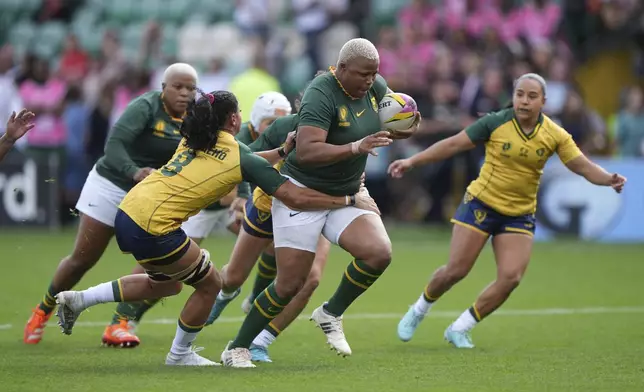 South Africa's Aseza Hele, right, is tackled by Brazil's Camilla Carvalho during the Women's Rugby World Cup 2025 Pool D match at Franklin's Gardens in Northampton, England, Sunday, Aug. 24, 2025. (Joe Giddens/PA via AP)/PA via AP)