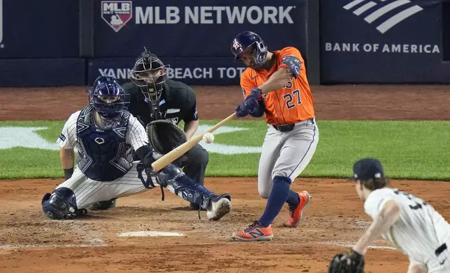 Houston Astros' Jose Altuve hits a double during the fifth inning of a baseball game against the New York Yankees Friday, Aug. 8, 2025, in New York. (AP Photo/Frank Franklin II)