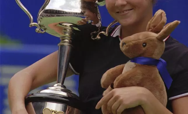 FILE - USA's Monica Seles holds the trophy and a toy Kangaroo after winning the women's final over Germany's Anke Huber at the Australian Open tennis Championships in Melbourne, Jan. 27, 1996. (AP Photo/Steve Holland, file)