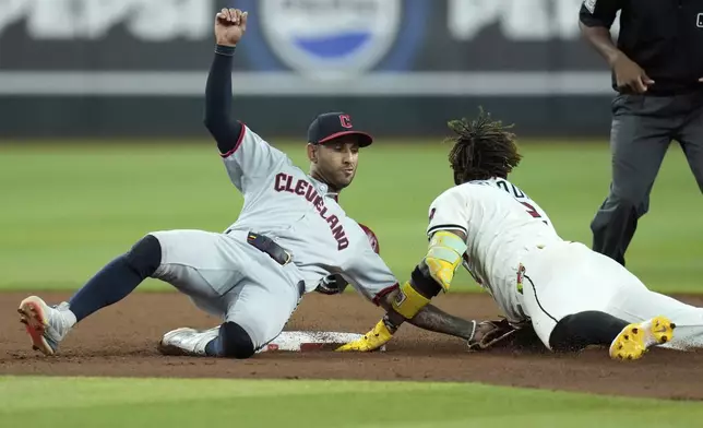 Arizona Diamondbacks' Geraldo Perdomo, right, steals second base as Cleveland Guardians second baseman Brayan Rocchio, left, is unable to make a catch during the seventh inning of a baseball game Tuesday, Aug. 19, 2025, in Phoenix. (AP Photo/Ross D. Franklin)