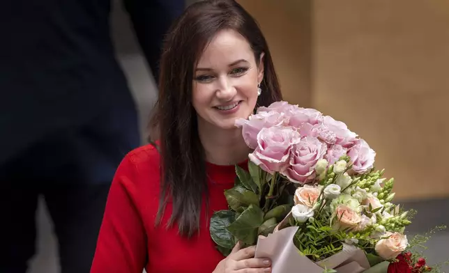 Lithuania's Social Democratic party member Inga Ruginiene smiles at the parliament after Lithuania's parliament approved her as the new Lithuania's Prime Minister, in Vilnius, Lithuania, Tuesday, Aug. 26, 2025. (AP Photo/Mindaugas Kulbis)