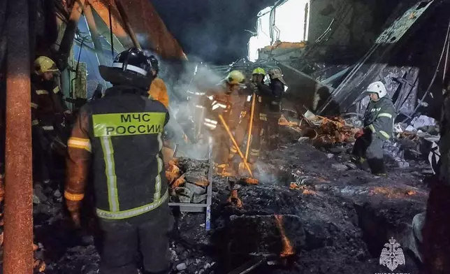 In this photo, released by the Russian Emergency Ministry Press Service on Saturday, Aug. 16, 2025, Emergency Ministry employees work in debris of an industrial plant after a fire at the facility in the Shilovsky District, Ryazan region, around 250 kilometers (155 miles) southeast of Moscow, Russia. (Russian Emergency Ministry Press Service via AP)