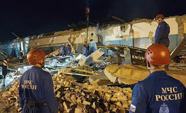 In this photo, released by the Russian Emergency Ministry Press Service on Saturday, Aug. 16, 2025, Emergency Ministry employees work in debris of an industrial plant after a fire at the facility in the Shilovsky District, Ryazan region, around 250 kilometers (155 miles) southeast of Moscow, Russia. (Russian Emergency Ministry Press Service via AP)