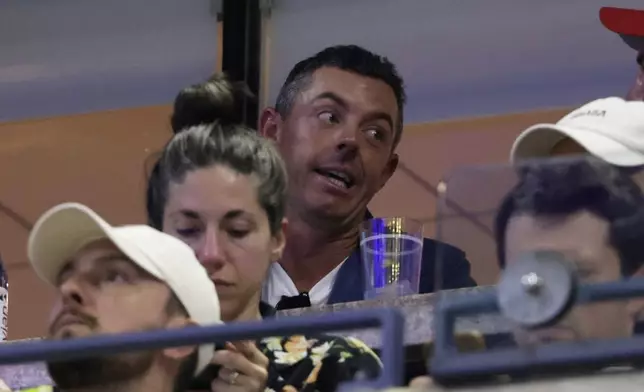 Rory McIlroy, of Northern Ireland, watches a match between Venus Williams, of the United States, and Karolina Muchova, of the Czech Republic, during the first round of the U.S. Open tennis championships, Monday, Aug. 25, 2025, in New York. (AP Photo/Adam Hunger)
