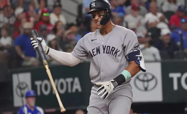 New York Yankees' Aaron Judge reacts to striking out during the fourth inning of a baseball game against the Texas Rangers, Tuesday, Aug. 5, 2025, in Arlington, Texas. (AP Photo/LM Otero)