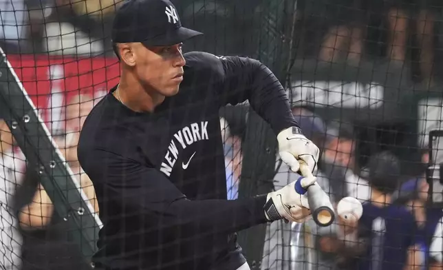 New York Yankees outfielder Aaron Judge bunts during batting practice before a baseball game against the Texas Rangers, Tuesday, Aug. 5, 2025, in Arlington, Texas. (AP Photo/LM Otero)