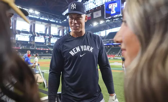 New York Yankees outfielder Aaron Judge chats with fans before a baseball game against the Texas Rangers, Tuesday, Aug. 5, 2025, in Arlington, Texas. (AP Photo/LM Otero)