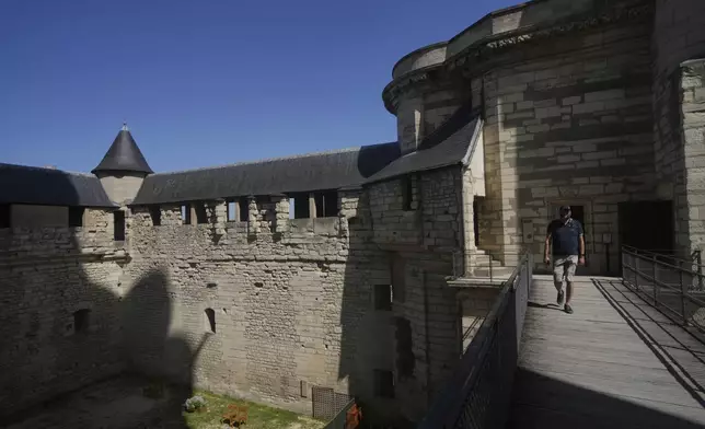 A man tours the Chateau de Vincennes, a massive fortress, just east of Paris, Tuesday, Aug. 12, 2025. (AP Photo/Aurelien Morissard)