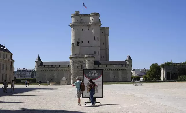 People arrive to visit the Chateau de Vincennes, a massive fortress just east of Paris, Tuesday, Aug. 12, 2025. (AP Photo/Aurelien Morissard)