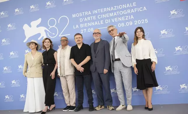 Jury president Alexander Payne, sixth from left, and jury members Zhao Tao, from left, Fernanda Torres, Mohammad Rasoulof, Cristian Mungiu, Stephane Brize and Maura Delpero pose for photographers at the Jury photo call during the 82nd edition of the Venice Film Festival in Venice, Italy, on Wednesday, Aug. 27, 2025. (Photo by Alessandra Tarantino/Invision/AP)