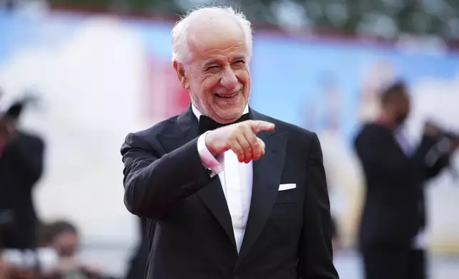Toni Servillo poses for photographers on the red carpet for the opening ceremony and the premiere of the film 'La Grazia' during the 82nd edition of the Venice Film Festival in Venice, Italy, on Wednesday, Aug. 27, 2025. (Photo by Scott A Garfitt/Invision/AP)