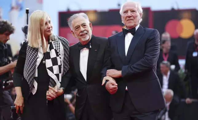 Lena Herzog, from left, Francis Ford Coppola, and Werner Herzog pose for photographers on the red carpet for the opening ceremony and the premiere of the film 'La Grazia' during the 82nd edition of the Venice Film Festival in Venice, Italy, on Wednesday, Aug. 27, 2025. (Photo by Scott A Garfitt/Invision/AP)