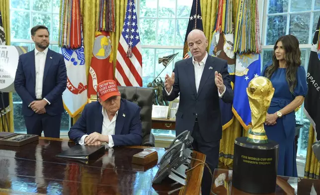 FIFA President Gianni Infantino speaks as Vice President JD Vance, from left, President Donald Trump and Homeland Security Secretary Kristi Noem listen in the Oval Office of the White House, Friday, Aug. 22, 2025, in Washington. (AP Photo/Jacquelyn Martin)