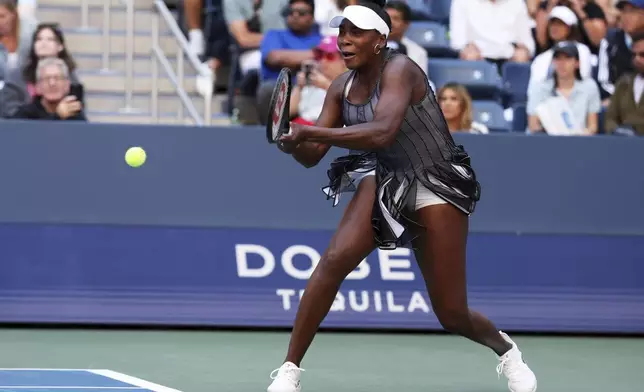 Venus Williams, of the United States, returns a shot during a doubles match with Leylah Fernandez, of Canada, during the third round of the U.S. Open tennis championships, Saturday, Aug. 30, 2025, in New York. (AP Photo/Heather Khalifa)